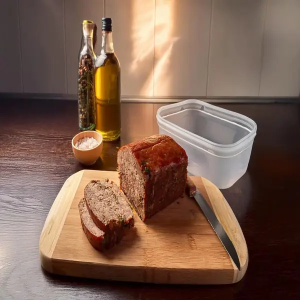 Freshly cooked meatloaf ready for storage with containers.