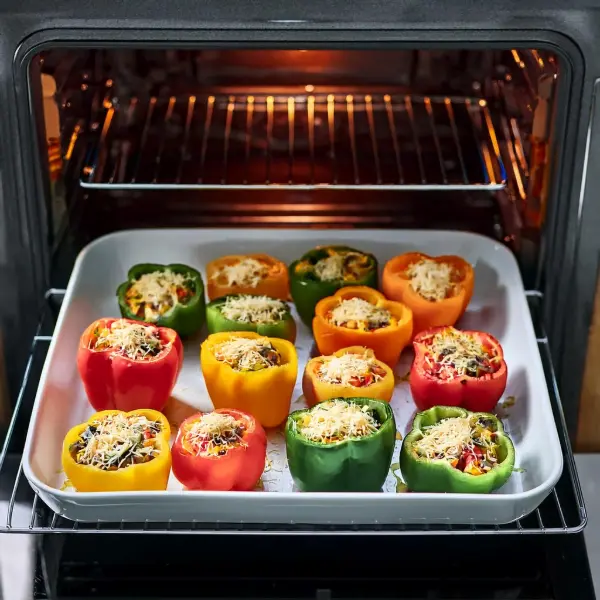 Stuffed peppers in a baking dish before baking