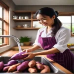 Person cleaning and peeling purple sweet potatoes in the kitchen