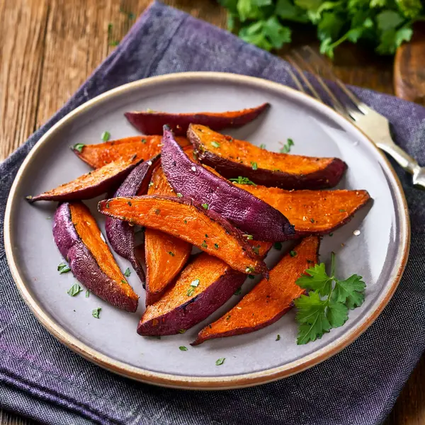 Plate of roasted purple sweet potato wedges
